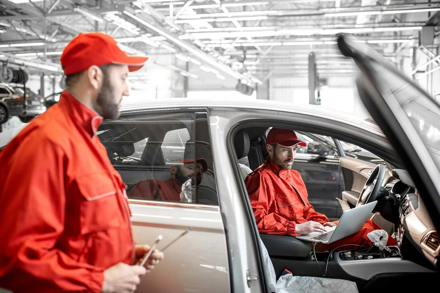 auto-mechanics-diagnosing-car-with-computer