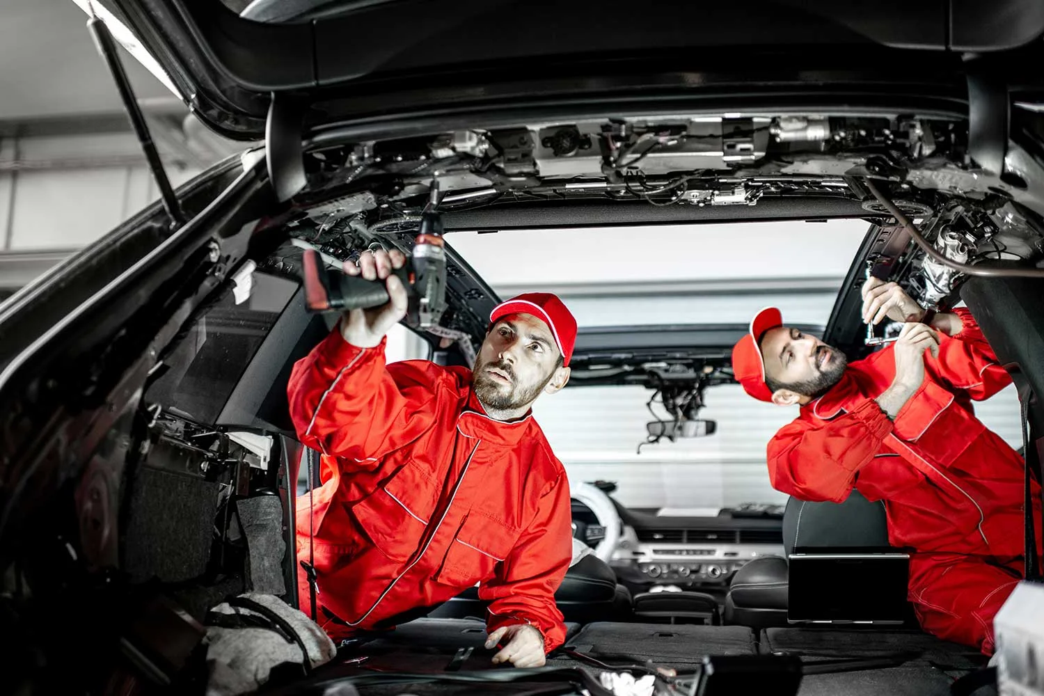 car-service-workers-disassembling-car-interior