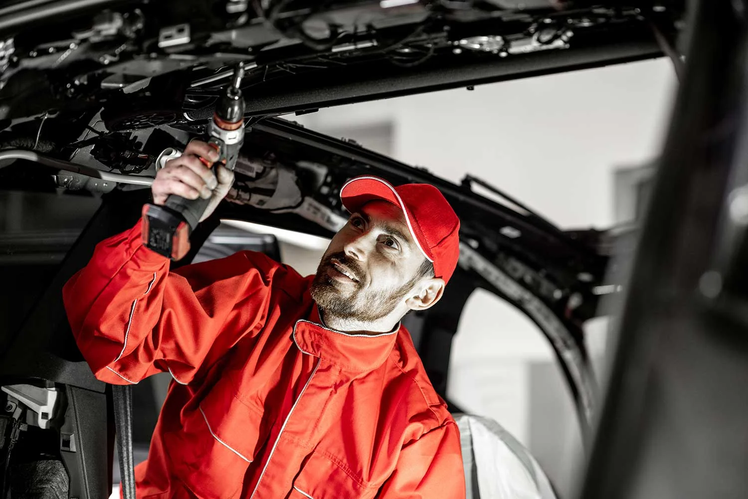 worker-disassembling-car-interior